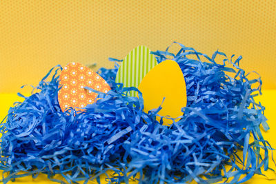 Close-up of multi colored candies against yellow background