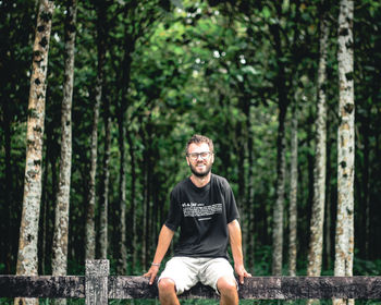 Portrait of man standing in forest