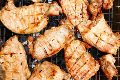 High angle view of meat on barbecue grill