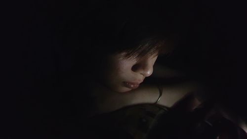Close-up of woman in darkroom