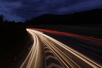 High angle view of light trails on highway at night