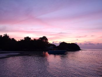 Scenic view of sea against romantic sky at sunset