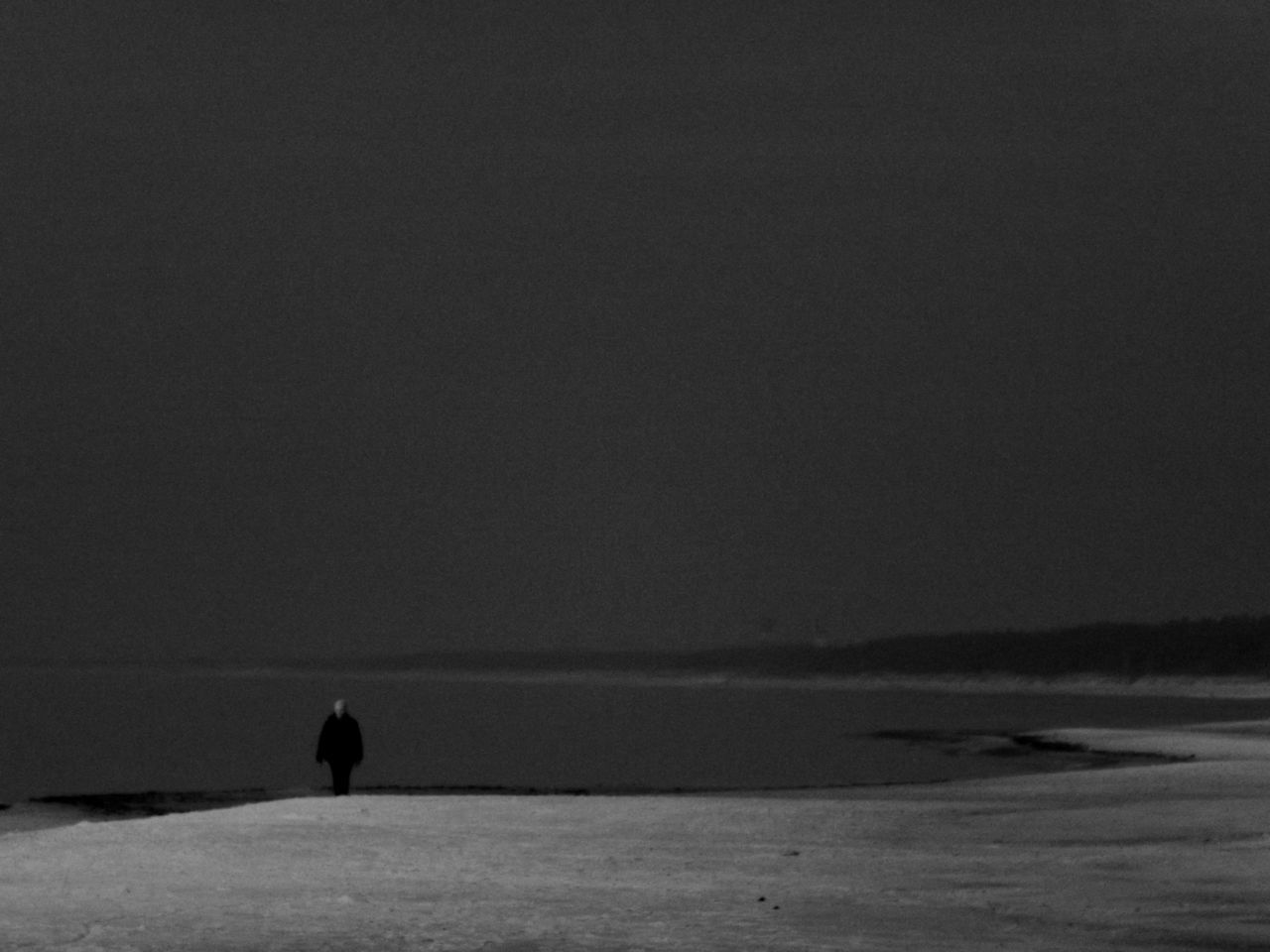 SILHOUETTE PERSON AT BEACH AGAINST SKY