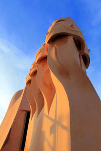 Low angle view of built structure against blue sky