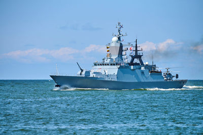 Battleship war ship corvette with helicopter on deck performing military exercises in baltic sea