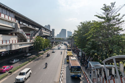 Cars on road amidst buildings in city against sky