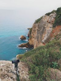 Rocks by sea against sky