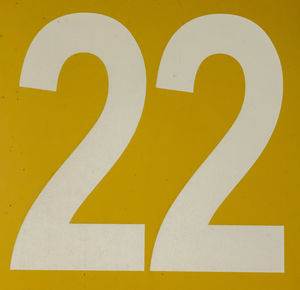 Close-up of yellow sign on wall