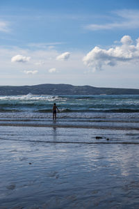 Person on beach against sea and  sky