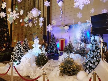 Statue of illuminated christmas tree in store