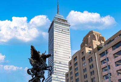 Low angle view of buildings against cloudy sky