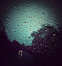 View of road seen through wet window