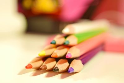 Close-up of multi colored pencils on table