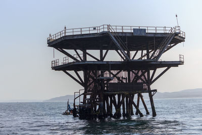 Gazebo in sea against clear sky