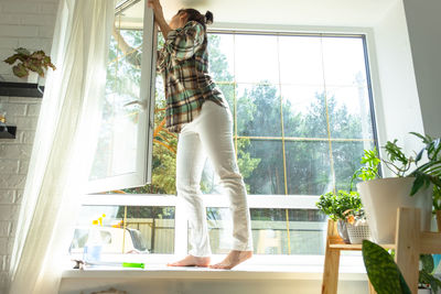 Full length of woman exercising at home