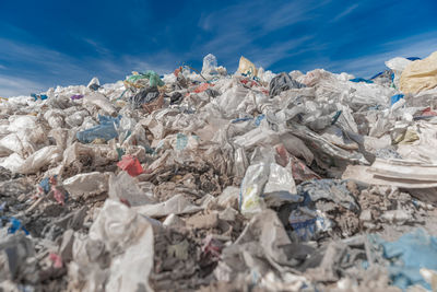 Close-up of garbage pile against sky