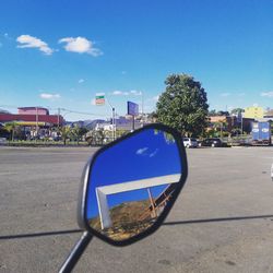 Car on street against blue sky