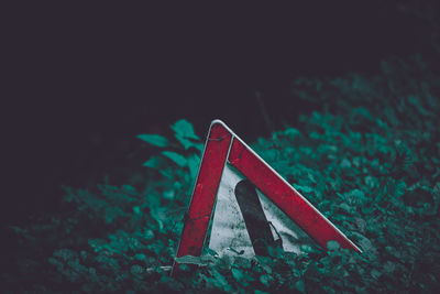 Close-up of red mailbox on field at night