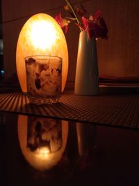 Close-up of illuminated candles on table