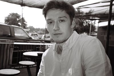 Portrait of young man in car