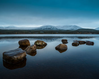 Scenic view of rocks in lake against sky