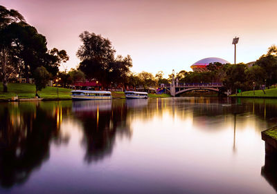 Scenic view of lake against clear sky at sunset