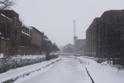 Snow covered road in city