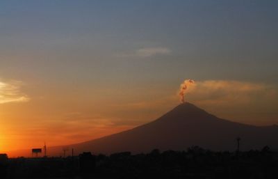 Scenic view of mountains against sky at sunset