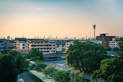 High angle view of buildings by river against clear sky