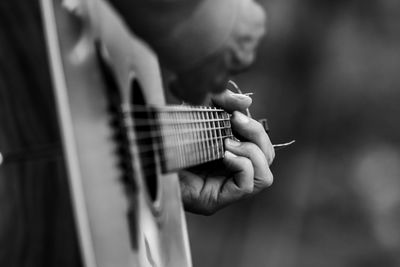 Cropped hand playing guitar