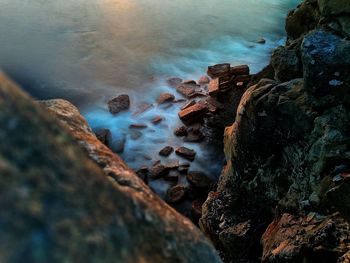 Rock formations in sea against sky