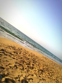 Scenic view of beach against clear sky