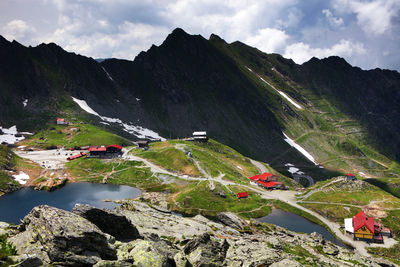 High angle view of lake and mountains against sky