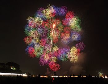 Low angle view of firework display at night