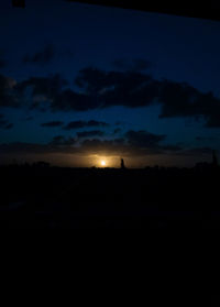 Silhouette landscape against sky at night