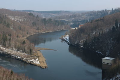 High angle view of river amidst trees against sky