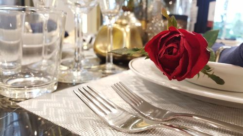 Close-up of red roses on table