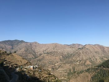 Scenic view of mountains against clear blue sky