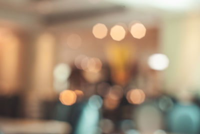 Defocused image of illuminated city street at night