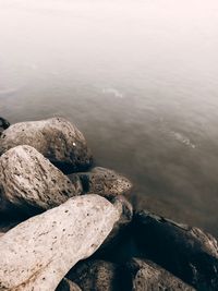 High angle view of rocks on shore against sky