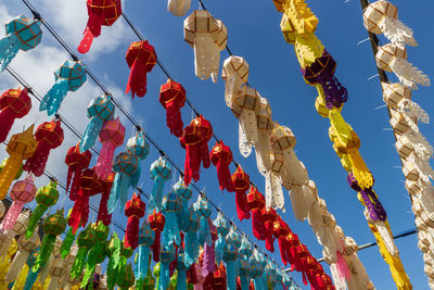 Low angle view of lanterns hanging against sky