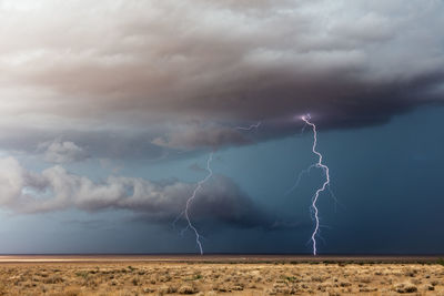 A thunderstorm with vivid lightning strikes  drifts across the desert near dolan springs, arizona.