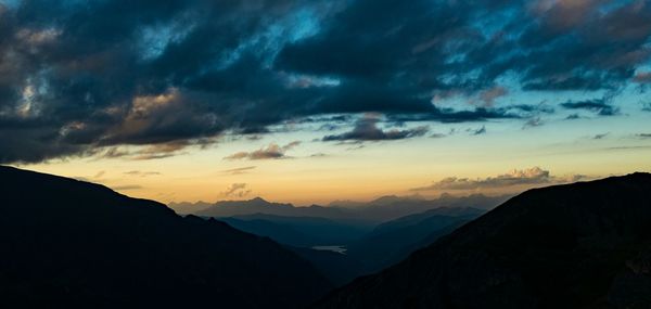 Scenic view of mountains against cloudy sky