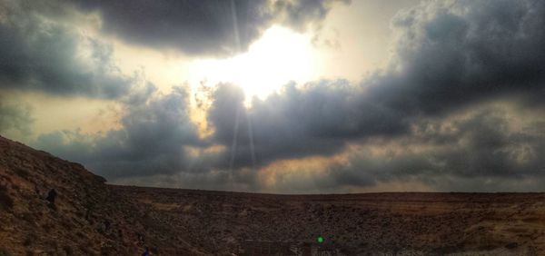 Scenic view of storm clouds over landscape against sky