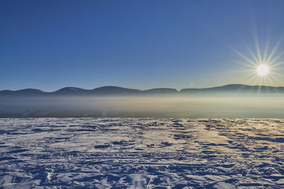 Scenic view of mountains against blue sky