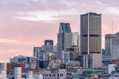 Skyscrapers against sky during sunset