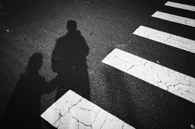 Shadow of man on road