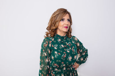 Portrait of smiling young woman against white background