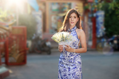 Portrait of a beautiful young woman standing outdoors