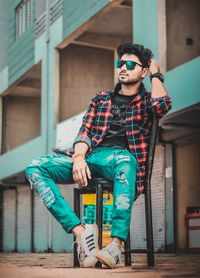 Portrait of young man sitting outdoors